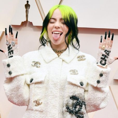 billie in a white channel outfit flexing her long nails